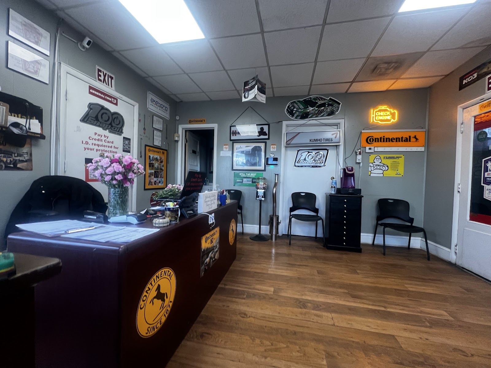 Front office with counter, tire brand signs and seating