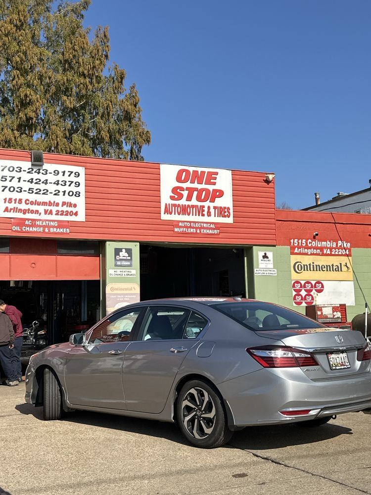 One Stop Automotive & Tires sign and phone numbers above the service bays