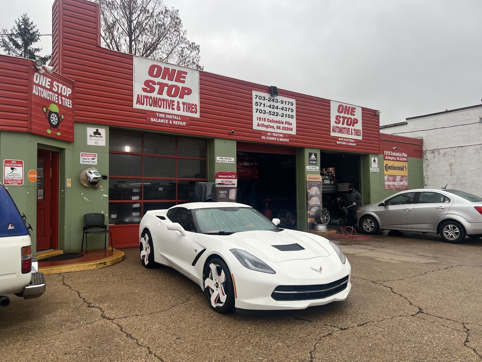 One Stop Automotive & Tires storefront on Columbia Pike: red and green building with open service bays